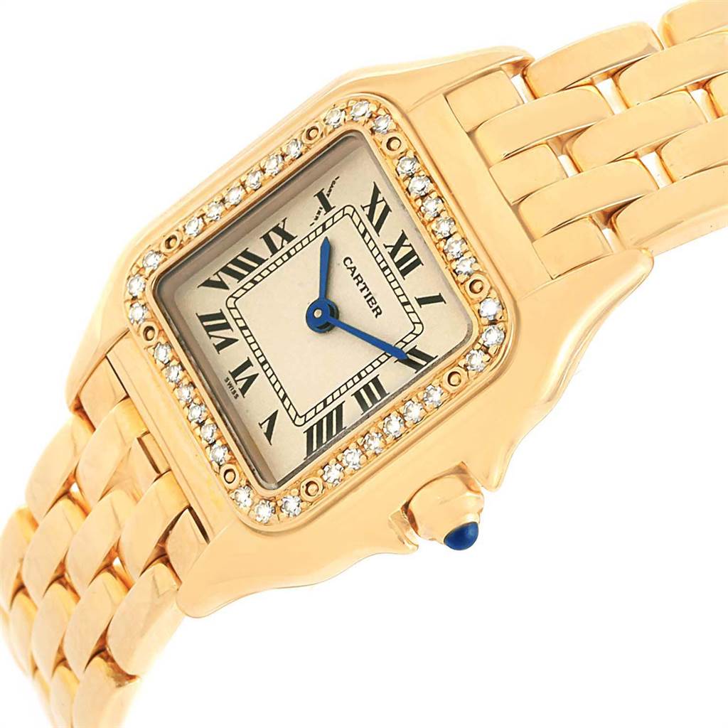 This image shows a Cartier Panthere WF3070B9 Women's Yellow Gold Beige Dial WF3070B9 Women's Yellow Gold Beige Dial watch at an angled view, highlighting the face, Roman numeral dial, diamond bezel, and gold bracelet.