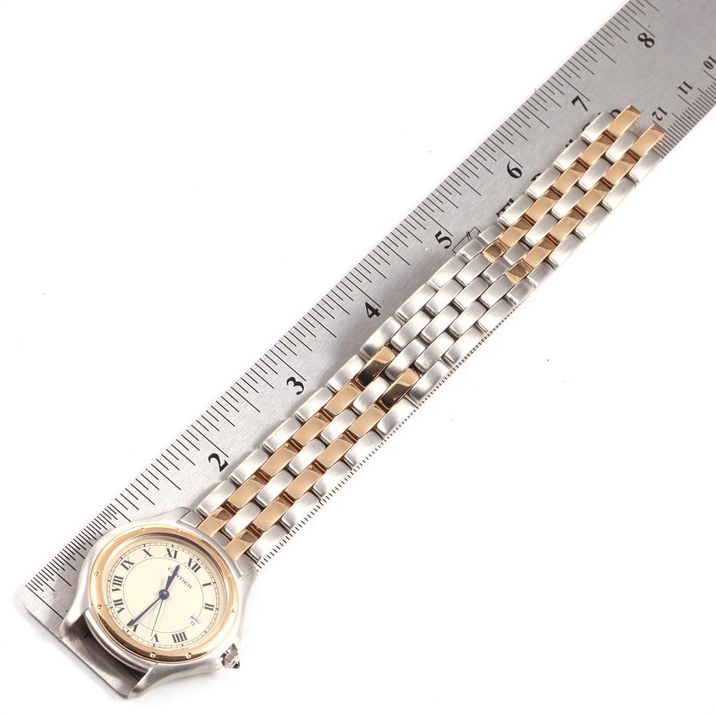 The image shows a Panthere model by Cartier watch laid flat with a ruler for scale, displaying its dial and part of the bracelet.