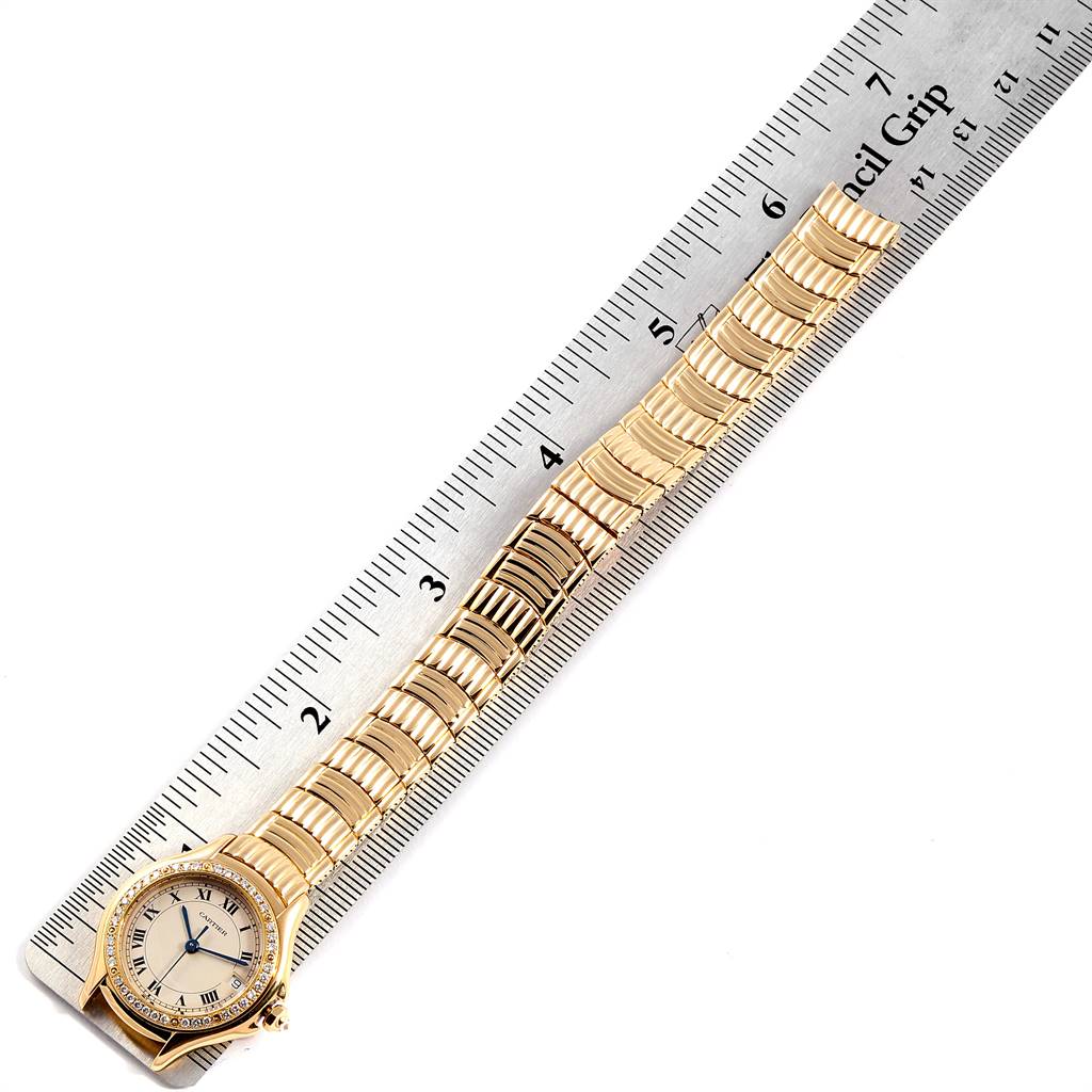 The image displays a Cartier Panthere 1171 Women's Yellow Gold Silver Dial 1171 Women's Yellow Gold Silver Dial model watch placed next to a ruler, showing its full length and bracelet details.