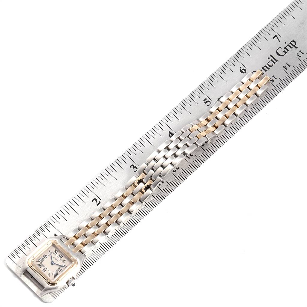 The image shows the Panthère model watch by Cartier, positioned alongside a ruler to display its length and bracelet detail.