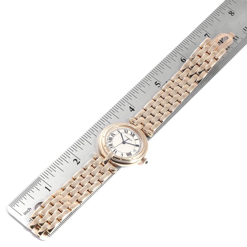 This image shows a Cartier Panthere 883964 Women's Yellow Gold Silver Dial 883964 Women's Yellow Gold Silver Dial watch laid flat alongside a ruler, displaying the face and bracelet at an angled view.
