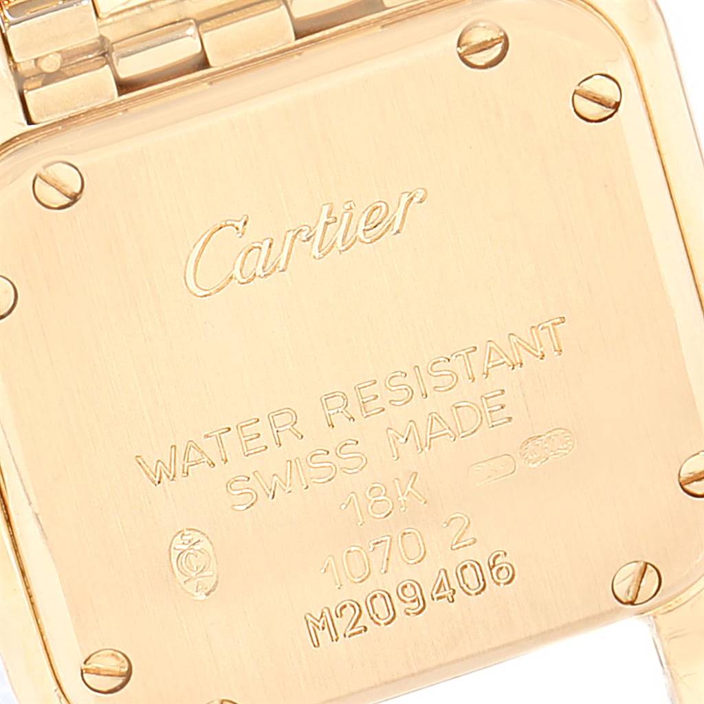 The image shows the back case of a Cartier Panthere Women's Yellow Gold Mother of Pearl Dial Women's Yellow Gold Mother of Pearl Dial watch, highlighting its engravings and screws.