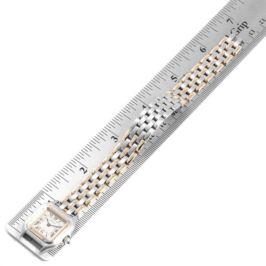 This image shows a Cartier Panthère watch at an angle with its case and bracelet resting on a ruler.