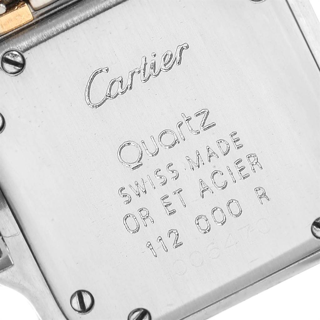 This image shows the back case of a Cartier Panthere W25029B6 Women's Stainless Steel Beige Dial W25029B6 Women's Stainless Steel Beige Dial watch viewed up close, highlighting inscriptions and screws.