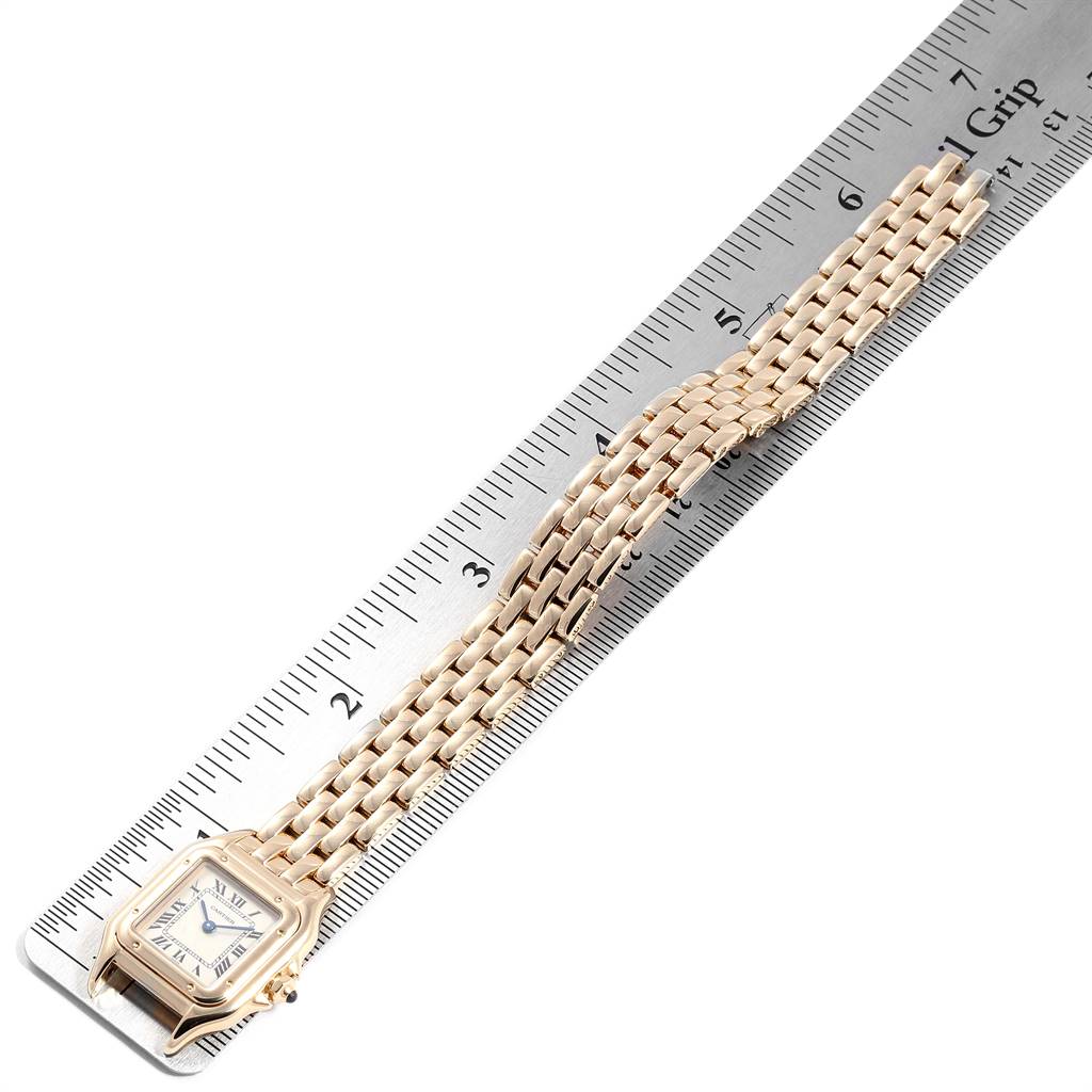 The image shows a Cartier Panthere W25022B9 Women's Yellow Gold Silver Dial W25022B9 Women's Yellow Gold Silver Dial model watch laid flat against a ruler, displaying the face and bracelet.