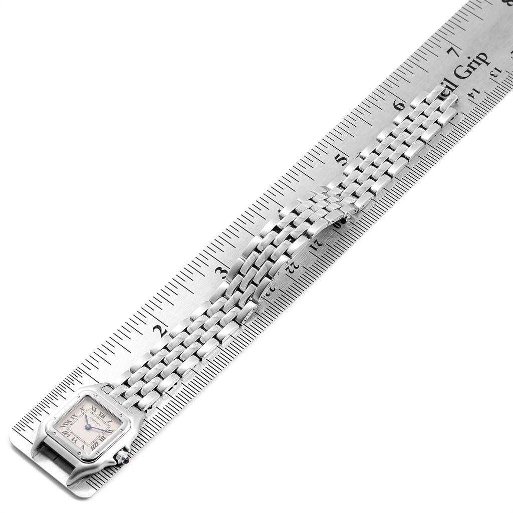 The image shows a top view of a Cartier Panthere W25033P5 Women
s Stainless Steel Silver Dial W25033P5 Women
s Stainless Steel Silver Dial watch with its linked band placed on a ruler for measurement.