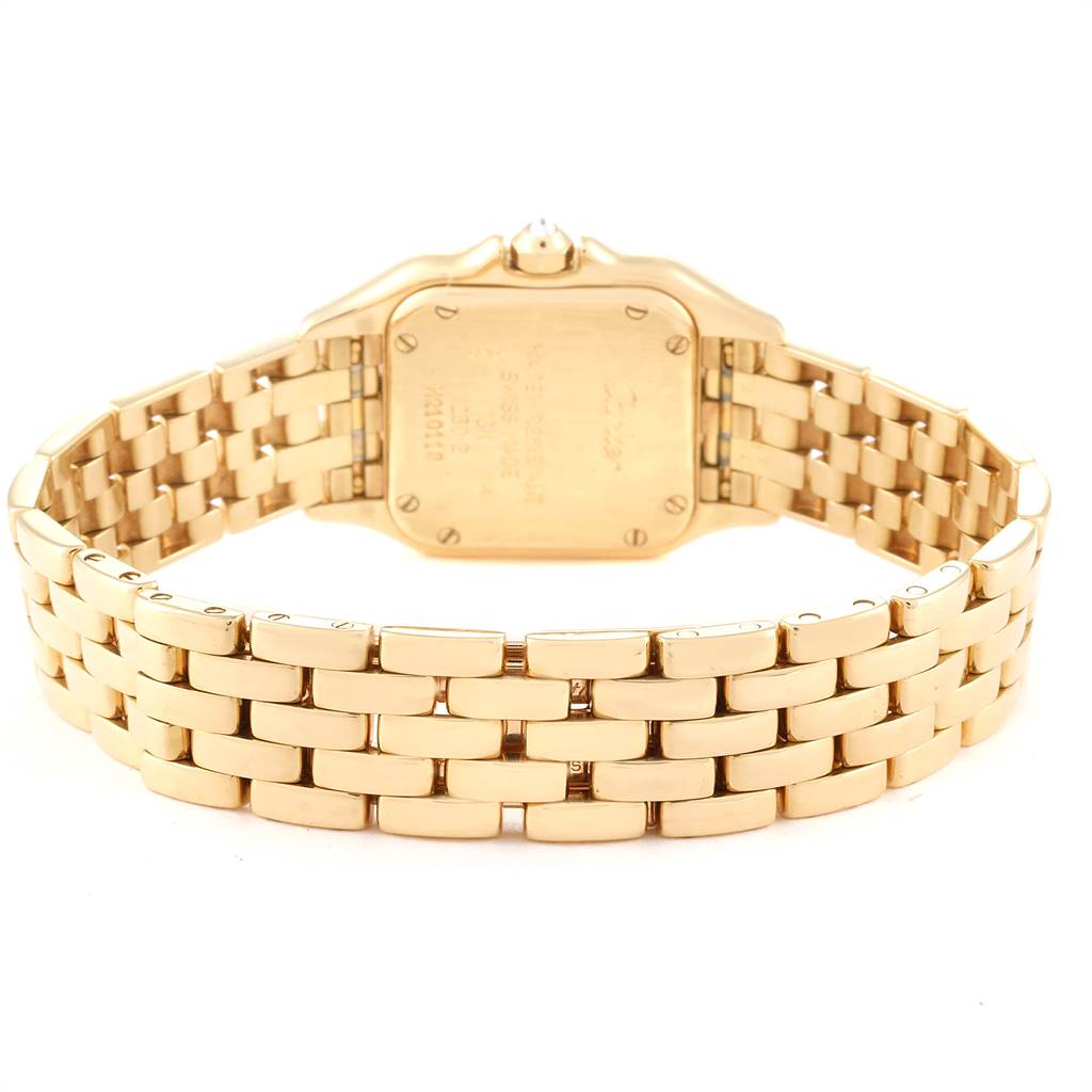The image shows the back view of the gold Panthere model by Cartier, highlighting its case back and bracelet.