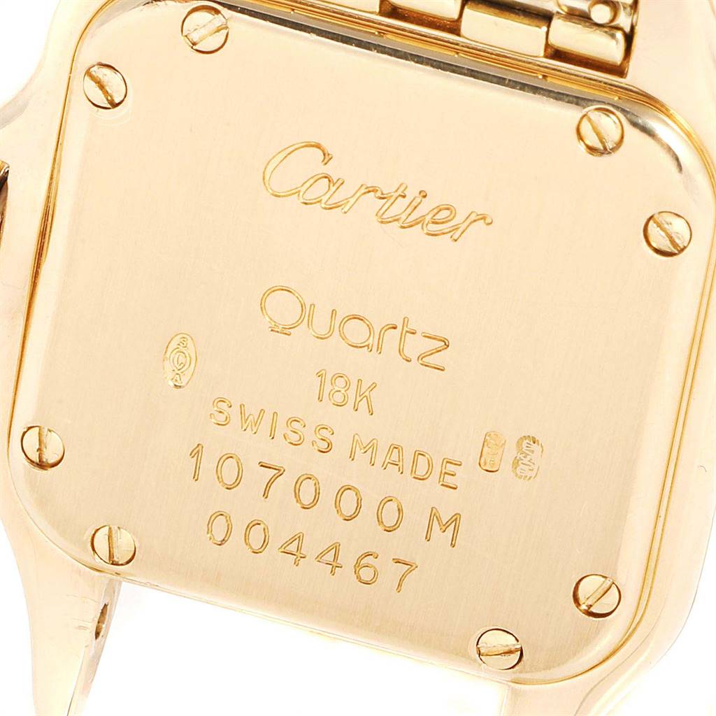This image shows a close-up of the back casing of a Panthere model Cartier watch in gold.