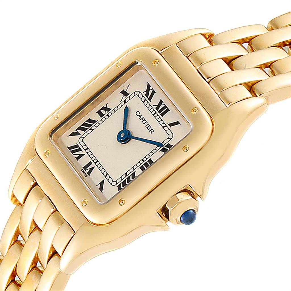 The image shows a Cartier Panthere W25022B9 Women's Yellow Gold Silver Dial W25022B9 Women's Yellow Gold Silver Dial watch angled to reveal its rectangular dial, Roman numerals, gold case, bracelet, and bejeweled crown.
