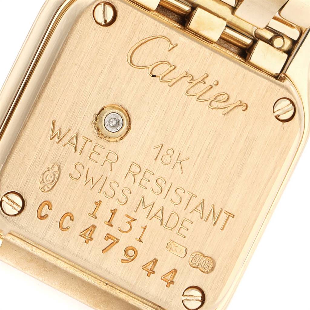 The image shows the back case of a Cartier Panthere 1131 Women's Yellow Gold Silver Dial 1131 Women's Yellow Gold Silver Dial watch, highlighting its engravings and screws.