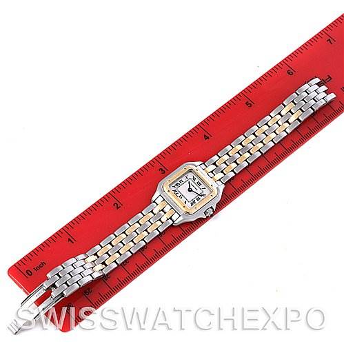 The image shows a Cartier Panthere W25029B6 Women
s Stainless Steel Silver Dial W25029B6 Women
s Stainless Steel Silver Dial watch from an overhead angle, with its bracelet and face aligned along a red ruler.