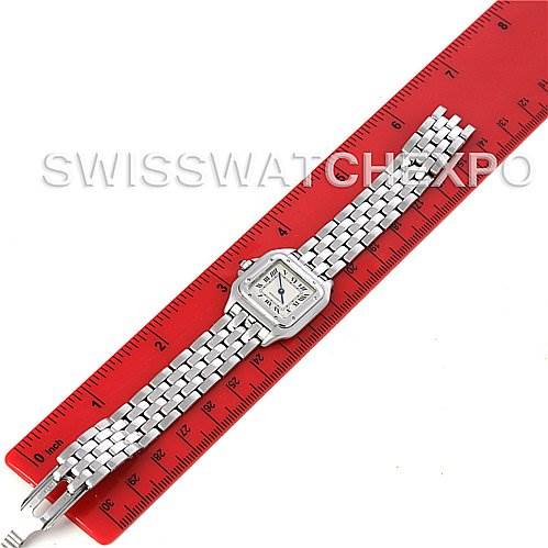 The image shows a top-down view of a Panthere model watch by Cartier laid lengthwise next to a red ruler.
