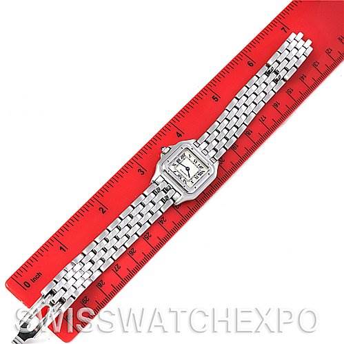 This image shows a Cartier Panthere W25033P5 Women
s Stainless Steel Silver Dial W25033P5 Women
s Stainless Steel Silver Dial watch laid flat next to a red ruler, highlighting the watch
s face and metal bracelet.