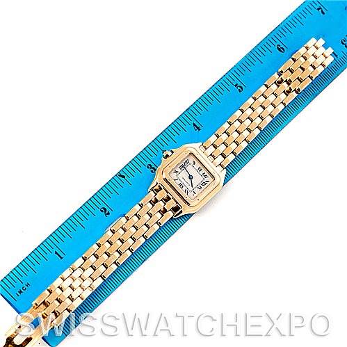 The image shows a top-down view of a Cartier Panthere W25022B9 Women's Yellow Gold Silver Dial W25022B9 Women's Yellow Gold Silver Dial watch placed beside a blue ruler.