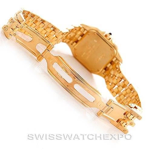 The image shows the clasp and reverse side of the band of a Cartier Panthere W25022B9 Women's Yellow Gold Silver Dial W25022B9 Women's Yellow Gold Silver Dial watch, with its distinctive golden links and deployment clasp.