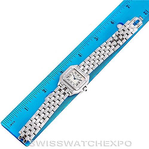 This image shows a Panthere model by Cartier laying flat against a blue ruler, featuring the watch
s face and metal bracelet.