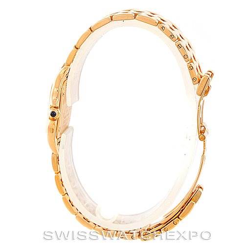 This is a side view of a Panthère de Cartier watch, showcasing the gold bracelet and crown with a blue cabochon.