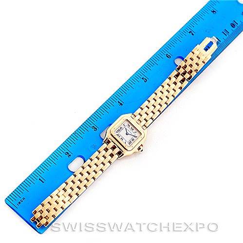 The Cartier Panthère watch is shown from a top-down angle, with the entire watch alongside a blue ruler for scale.