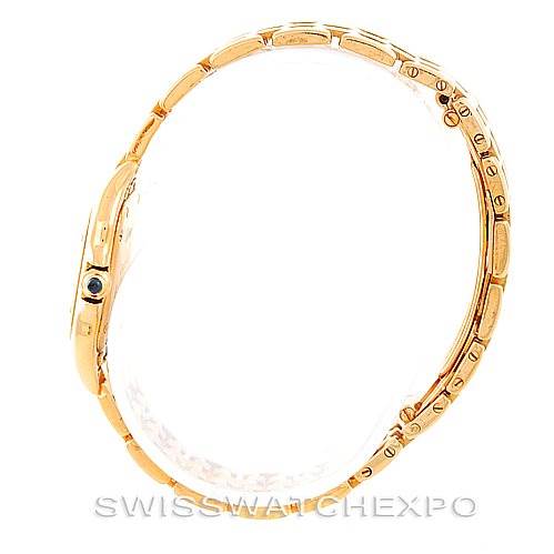 The Cartiere Panthere watch is shown from a side angle, highlighting its bracelet and case profile in gold.