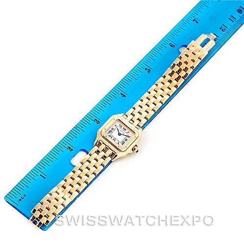 The image shows the full length of a Cartier Panthere W25022B9 Women's Yellow Gold Silver Dial W25022B9 Women's Yellow Gold Silver Dial watch alongside a blue ruler for scale.