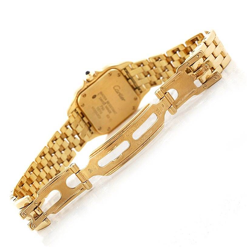 The image shows the backside and clasp of the Cartier Panthère watch, highlighting its gold bracelet and engraved details.