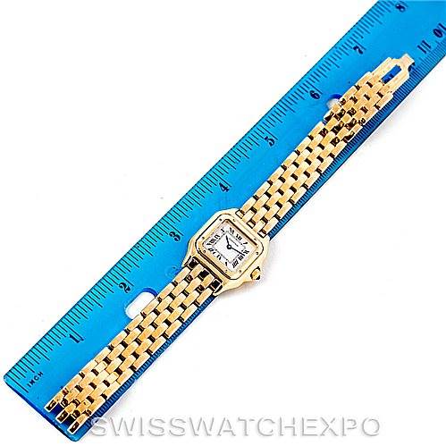 The image shows a top-down view of a Cartier Panthere W25022B9 Women's Yellow Gold Silver Dial W25022B9 Women's Yellow Gold Silver Dial model watch placed next to a blue ruler for scale.