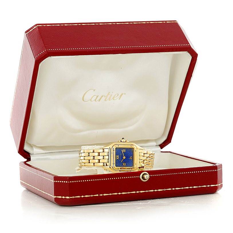The Panthere de Cartier watch is shown inside its open red Cartier case, highlighting its blue dial and gold bracelet.