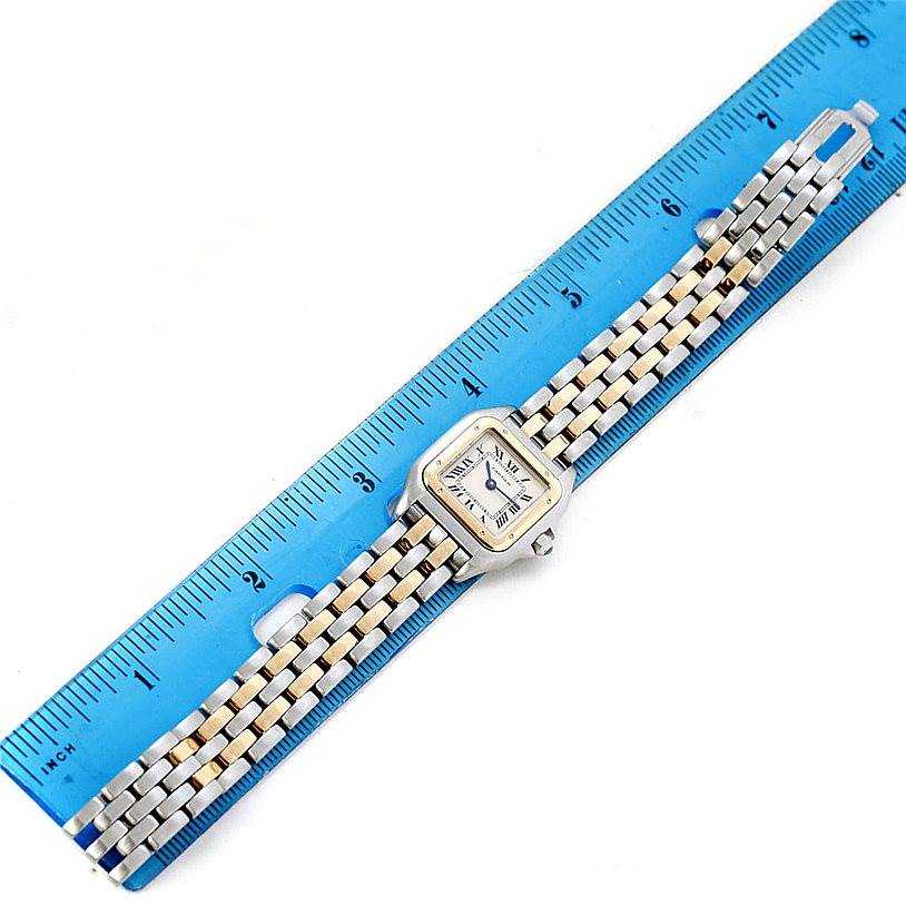 The image shows a Cartier Panthere W25029B6 Women
s Stainless Steel Silver Dial W25029B6 Women
s Stainless Steel Silver Dial watch laid flat next to a blue ruler, displaying the face, bezel, and bracelet.