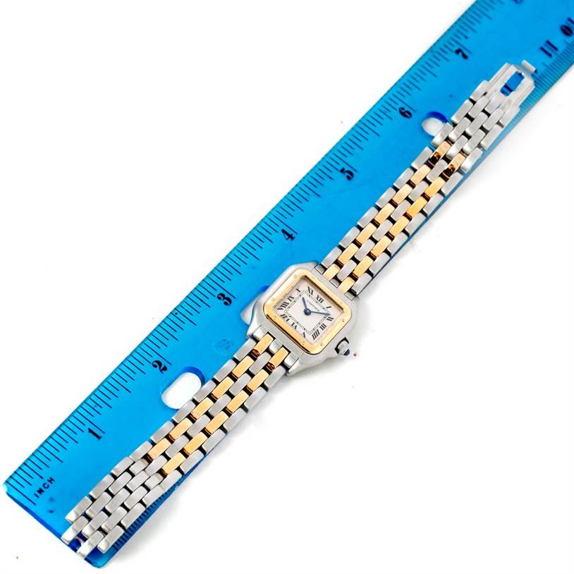 The Cartier Panthere W25029B6 Women
s Stainless Steel Silver Dial W25029B6 Women
s Stainless Steel Silver Dial watch is shown from a top view, displaying the face and two-tone band alongside a blue ruler.