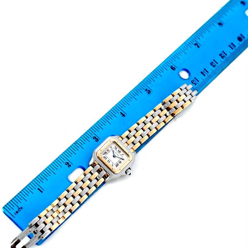 The image shows a Cartier Panthere W25029B6 Women
s Stainless Steel Silver Dial W25029B6 Women
s Stainless Steel Silver Dial watch lying flat along a blue ruler, highlighting its face and bracelet.