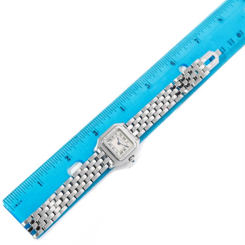 The image shows the Cartier Panthère watch from a top-down angle, placed next to a blue ruler for scale.