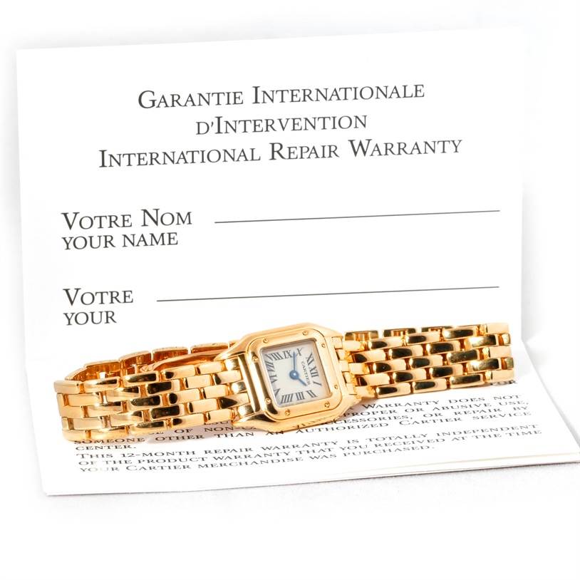 This image shows a Cartier Panthere W25034B9 Women's Yellow Gold Silver Dial W25034B9 Women's Yellow Gold Silver Dial watch laid on top of an international repair warranty card.