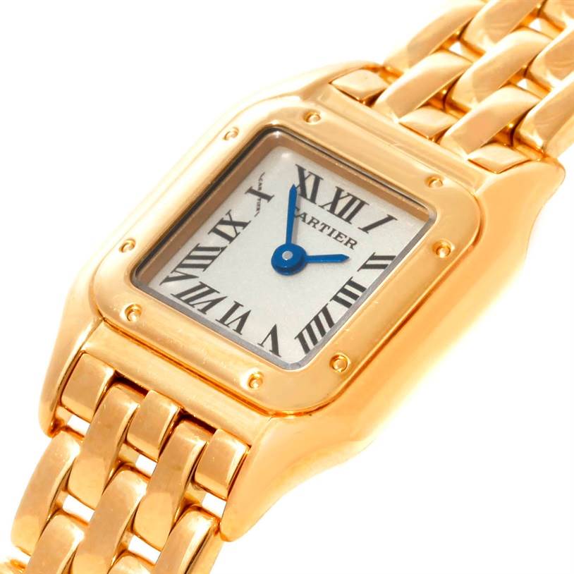 The Panthere de Cartier watch is shown at an oblique angle, highlighting its gold rectangular case, Roman numeral dial, and linked bracelet.