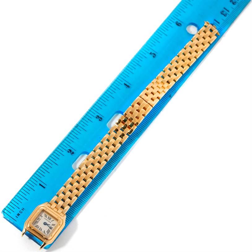 The Cartier Panthere W25034B9 Women's Yellow Gold Silver Dial W25034B9 Women's Yellow Gold Silver Dial watch is shown from a top view, displaying the face, case, and full bracelet against a measuring ruler.