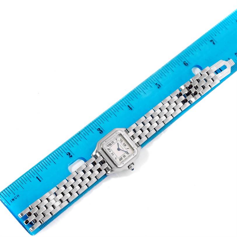 The Cartier Panthere W25033P5 Women
s Stainless Steel Silver Dial W25033P5 Women
s Stainless Steel Silver Dial watch is shown flat next to a blue ruler, highlighting the face and metal link band.
