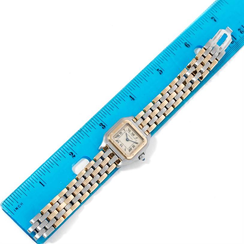 The image shows a top view of a Cartier Panthere W25029B6 Women's Stainless Steel Beige Dial W25029B6 Women's Stainless Steel Beige Dial watch, including its face, bracelet, and clasp, with a blue ruler for scale.