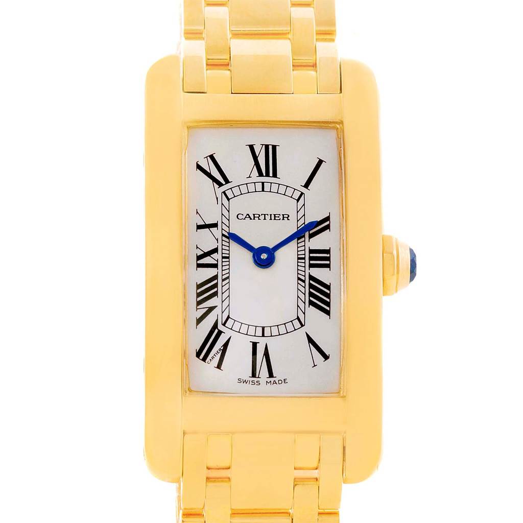 The image shows a Cartier Tank Américaine watch from a front angle, displaying its rectangular face, Roman numerals, and golden bracelet.
