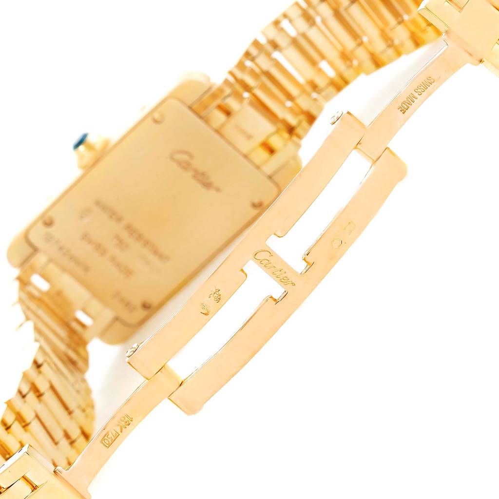 The image shows the back case and part of the bracelet of a Cartier Tank Américaine watch.