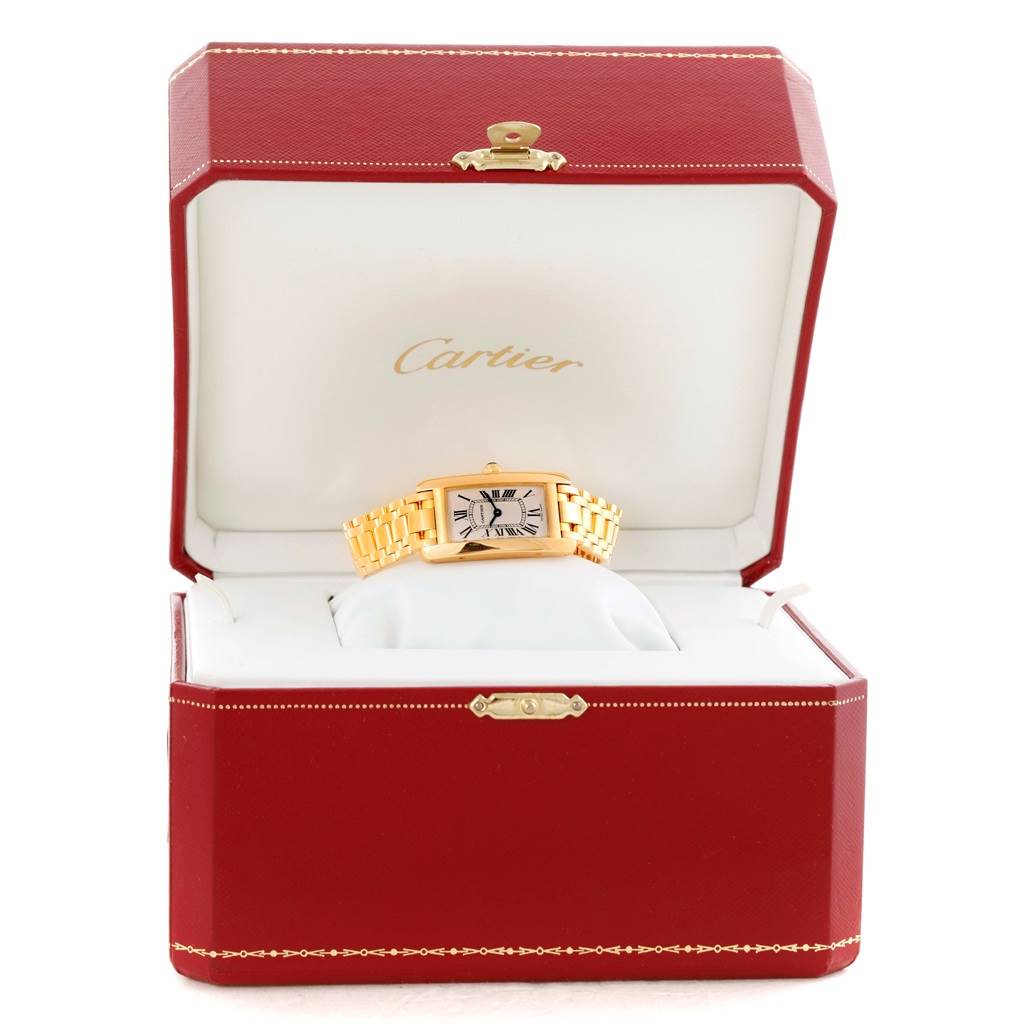 The image shows a Cartier Tank Americaine W26015K2 Women's Yellow Gold Silver Dial W26015K2 Women's Yellow Gold Silver Dial watch front-facing, displayed in an open red Cartier box.