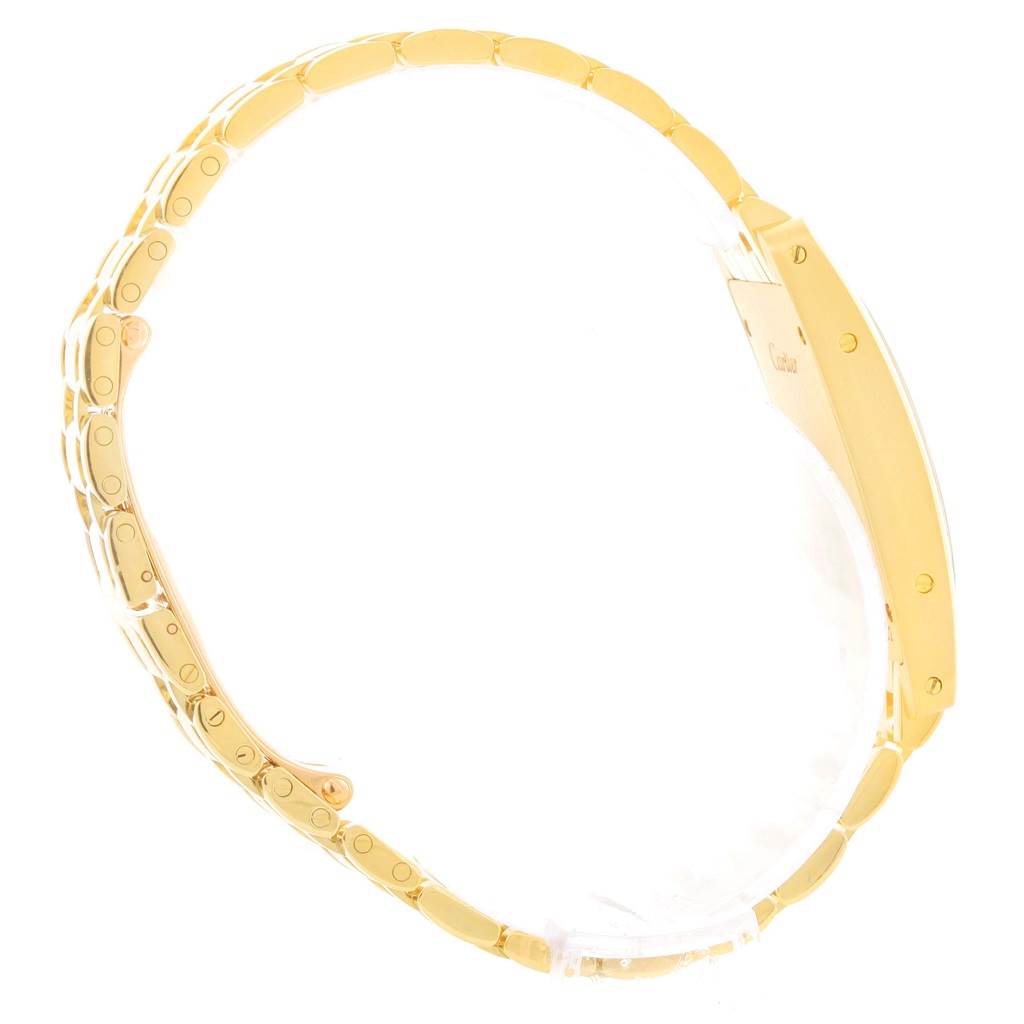 This is a side view of the Cartier Tank Americaine W26015K2 Women's Yellow Gold Silver Dial W26015K2 Women's Yellow Gold Silver Dial watch, showcasing its gold bracelet and case.