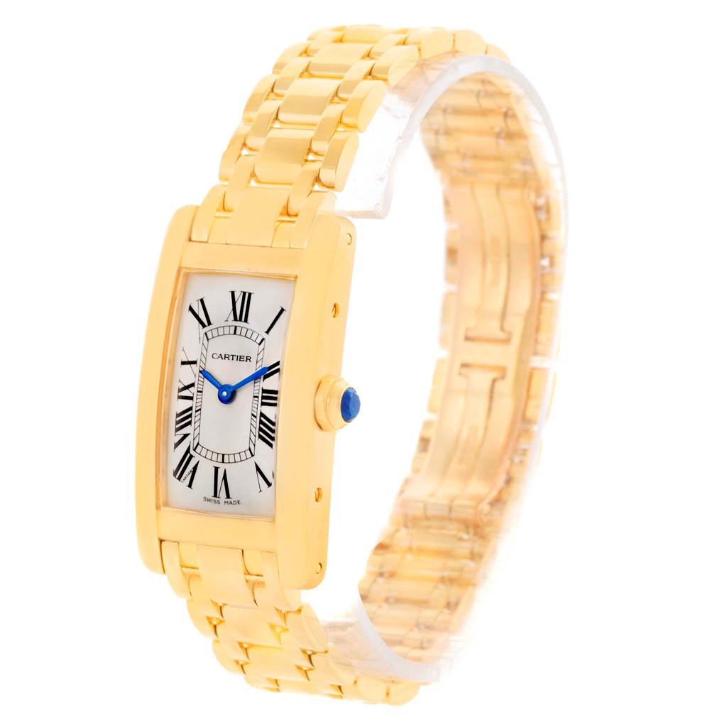 The image shows a Cartier Tank Americaine W26015K2 Women's Yellow Gold Silver Dial W26015K2 Women's Yellow Gold Silver Dial watch angled to display the dial, case, and part of the bracelet.