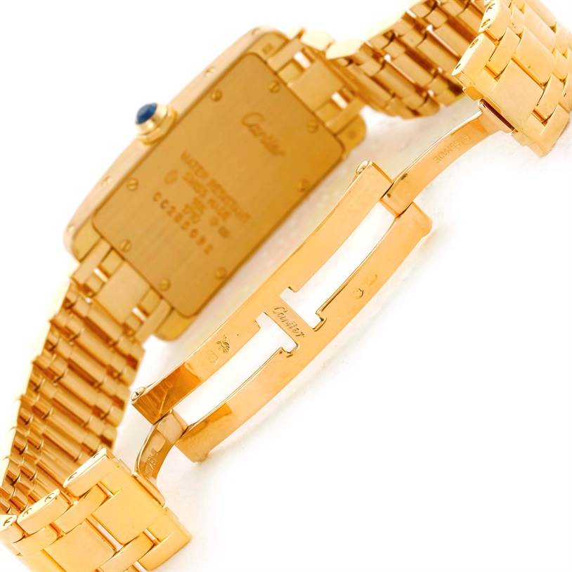 The image shows the back side and clasp of a Cartier Tank Americaine W26015K2 Women's Yellow Gold Silver Dial W26015K2 Women's Yellow Gold Silver Dial watch.