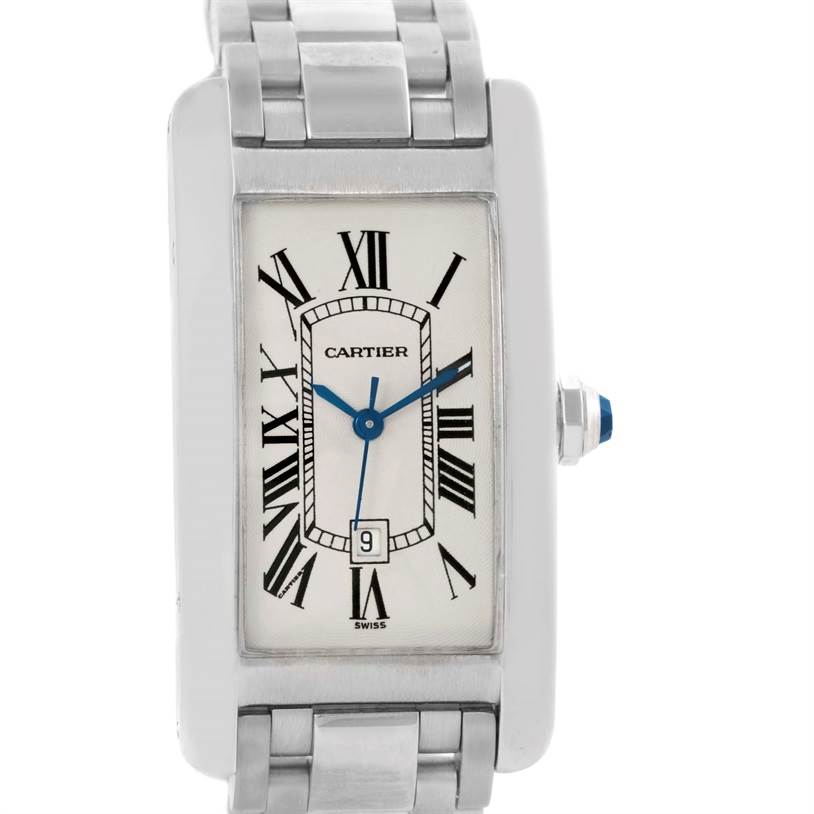 The image shows a front view of a Cartier Tank Américaine watch, displaying its rectangular face, Roman numerals, blue hands, and metal bracelet.