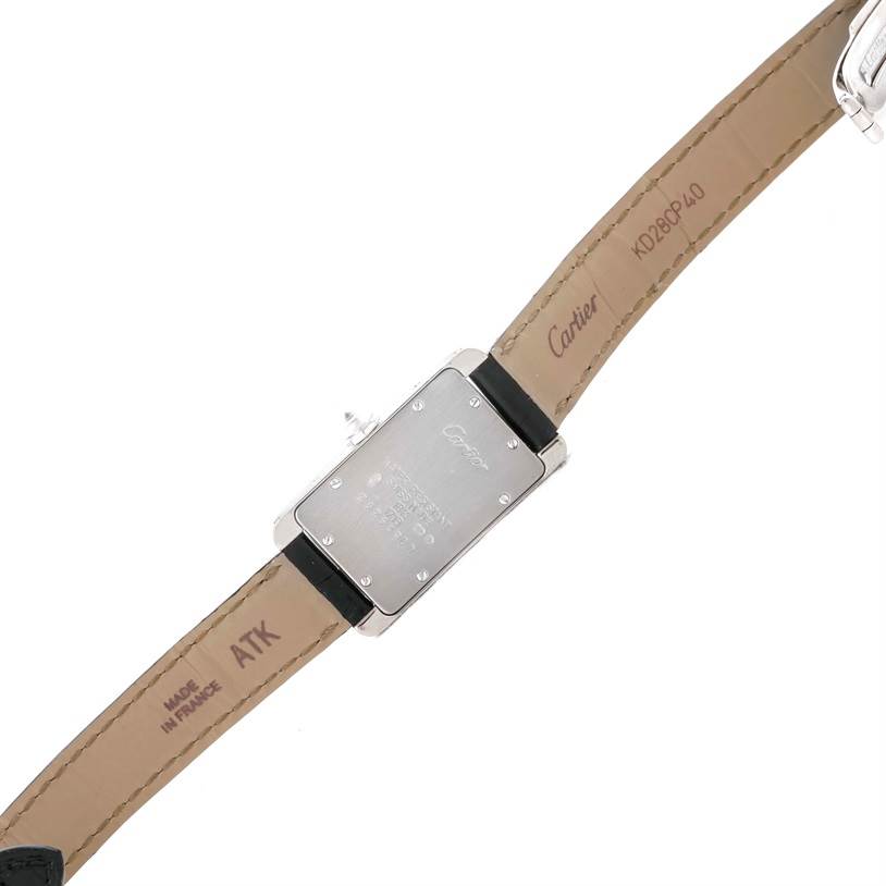 This image shows the underside of a Cartier Tank Américaine watch, displaying the case back and leather strap.