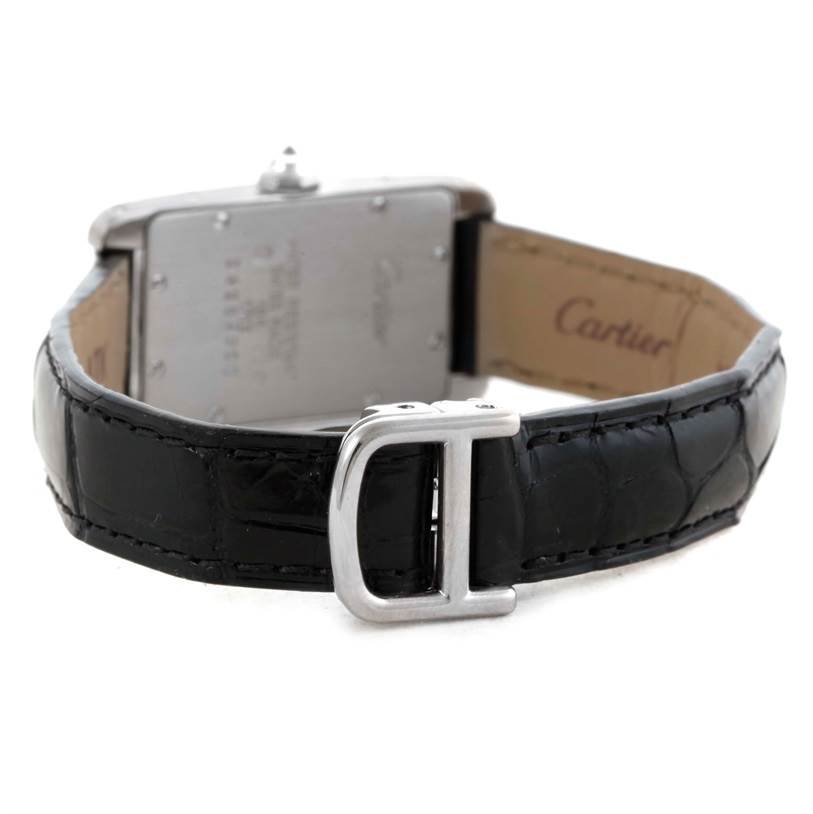 The image shows the back view of a Cartier Tank Americaine WB701851 Men's White Gold Silver Dial WB701851 Men's White Gold Silver Dial watch, highlighting the leather strap and the buckle.