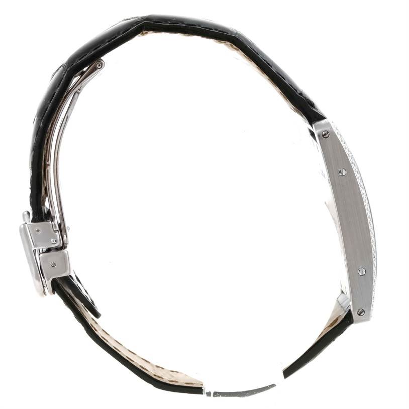 The image shows a side view of the Tank Americaine watch by Cartier, displaying the strap and the side profile of the case.