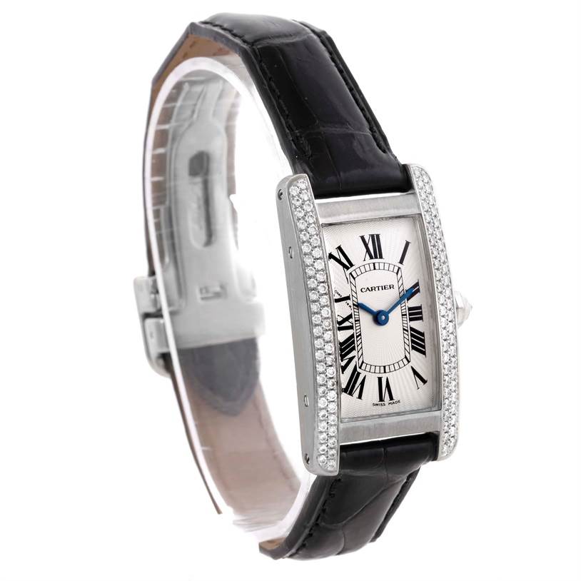 The Cartier Tank Americaine WB701851 Men's White Gold Silver Dial WB701851 Men's White Gold Silver Dial watch is shown at an angled view, featuring its face, bezel with diamonds, and black leather strap.