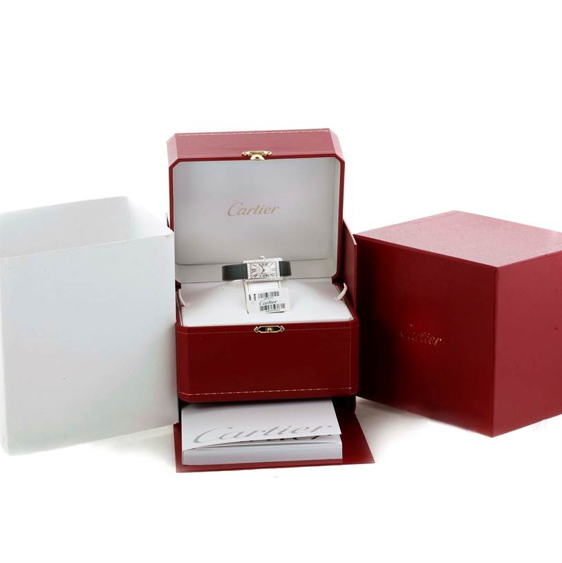 The Cartier Tank Americaine WB707331 Women
s White Gold Silver Dial WB707331 Women
s White Gold Silver Dial watch is shown in its open red box, with accompanying packaging and booklet visible.