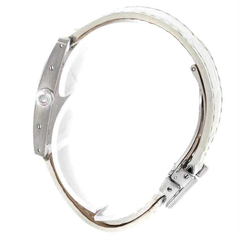 A side view of the Cartier Tank Americaine WB701851 Women
s White Gold Silver Dial WB701851 Women
s White Gold Silver Dial watch, highlighting its crown and white leather strap.