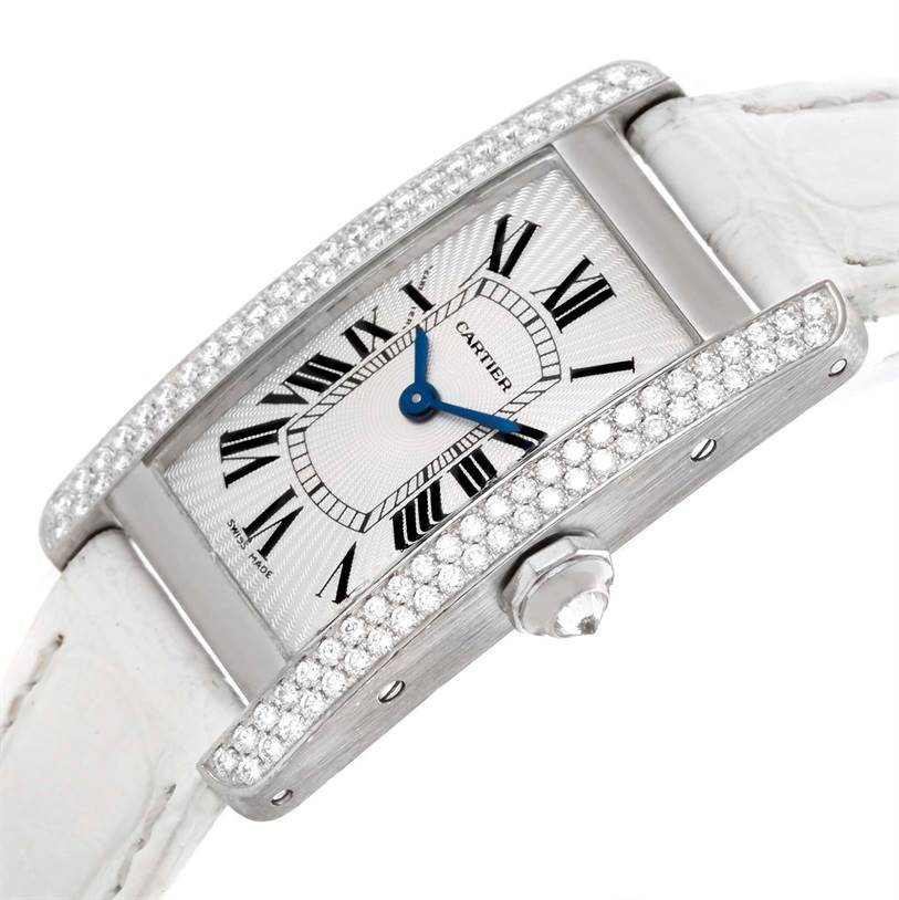 The image shows an angled view of the Cartier Tank Americaine WB701851 Women
s White Gold Silver Dial WB701851 Women
s White Gold Silver Dial watch, focusing on its diamond-encrusted bezel, face, and crown.